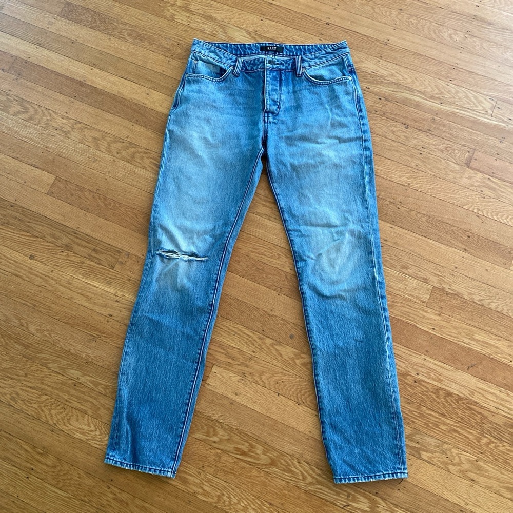 Neuw blue Lou jeans with ripped knee. Button fly and in great condition.